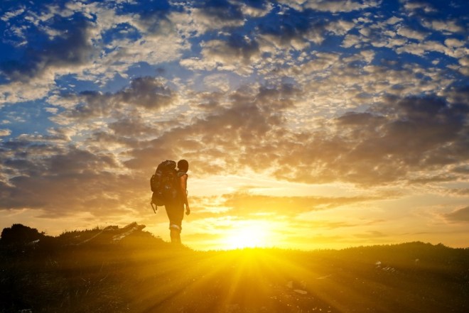 hiker in a mountains at the sunset